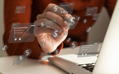 Online shopping and e-commerce concept. Young man using laptop computer with shopping cart icon, order in online store, shopping on internet, concept on virtual screen with hands typing on keyboard