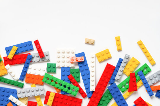 Border of Various Toy Blocks on White: Creative Construction Play. Lego blocks. Novosibirsk, Russia - October 26, 2023.