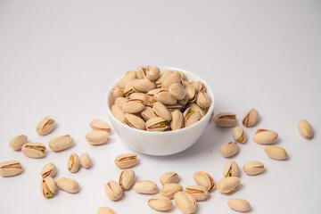 Yellow Apricot or yellow dry fruits on white bowl with white background, Yellow Apricot or yellow dry fruits scattered on white bowl with white background