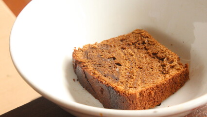 cropped image of slice of bread on a bowl