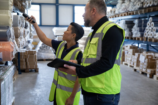 Portrait of employee in distribution warehouse being trained to export products
