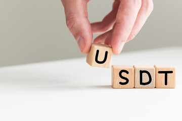 text usdt on vertical row of wooden blocks on the background of columns of numbers. USD text on wooden cubes on blue backround. Business concept.