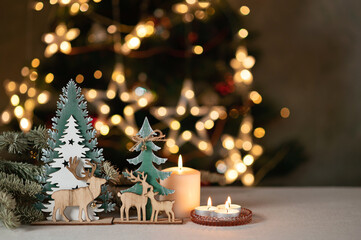 Christmas cozy holiday interior home decoration in Nordic style, wooden deer figurines, pine...
