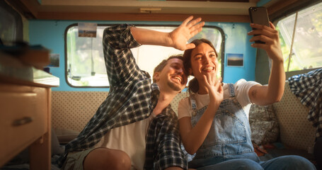 Happy Smiling Couple Taking a Selfie Photo for Family, Relatives or Friends. Having Funny Conversations on Video Call. Young Man and Woman Travelling in a Motorhome, Recording Video for Social Media