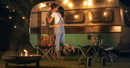 Close Up on Legs of a Couple Dancing Next to Campfire at a Camping Rest Area in the Evening. Female...