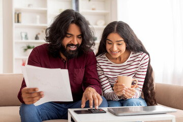 Indian Married Couple Planning Budget Together At Home