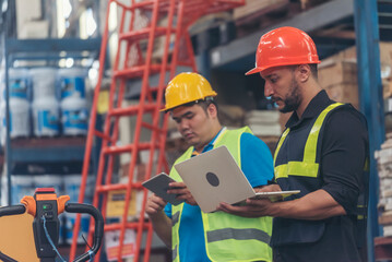 Warehouse management multiracial team partner engineer man work together checklist stock control. Warehouse worker teamwork diversity men using laptop logistics counting products store inventory.