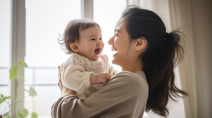Playful Moments: A parent engaging in playful interaction with their baby in arms, showcasing the joy of play and connection