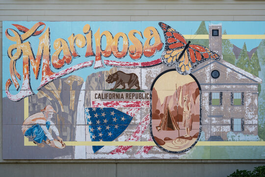 Mariposa, USA - 04, 28, 2023: mural depicting story of town with inscription flag bear and butterfly on building wall