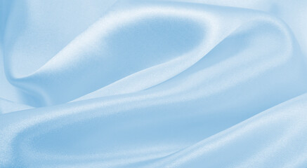 Smooth elegant blue silk or satin luxury cloth texture as abstract background. Luxurious background design
