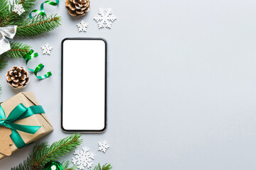 Digital phone mock up with rustic Christmas decorations for app presentation top view with empty...