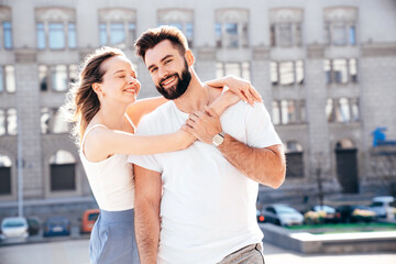 Smiling beautiful woman and her handsome boyfriend. Woman in casual summer clothes. Happy cheerful family. Female having fun. Couple posing in street at sunny day. Having tender moments