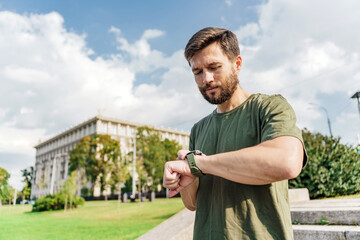 Sad trainer uses a fitness app to look at the progress after a workout. The runner is a sporty...