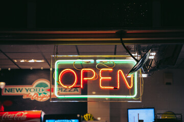 Neon sign "OPEN" at a store at night