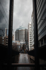 Τall urban building framed between railings downtown Den Haag