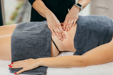 Female hands doing abdominal massage