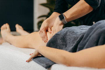 Female hands doing leg massage