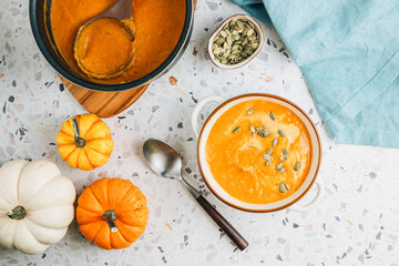 Roasted pumpkin and carrot soup with cream and pumpkin seeds