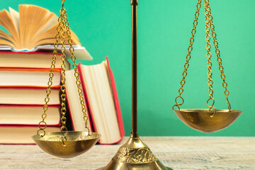 Law concept - Open law book, Judge's gavel, scales, Themis statue on table in a courtroom or law...