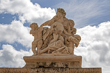 White marble statues of Versailles castle in the city of Paris - PARIS, FRANCE - June 27, 2012.
