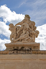Fototapeta premium White marble statues of Versailles castle in the city of Paris - PARIS, FRANCE - June 27, 2012.