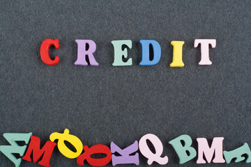 CREDIT word on black board background composed from colorful abc alphabet block wooden letters, copy space for ad text. Learning english concept.