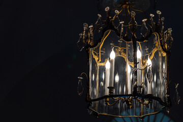Luxury vintage chandelier with electric candle lights glowing inside