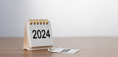 2024 Happy New year background. Turns over a calendar sheet. Setup objective target business cost and budget planning of new year concept. year change from 2023 to 2024. - obrazy, fototapety, plakaty