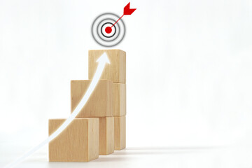 Shining rise up arrow shoot up towards the goal icon on the top of wooden cube block. Concept of...