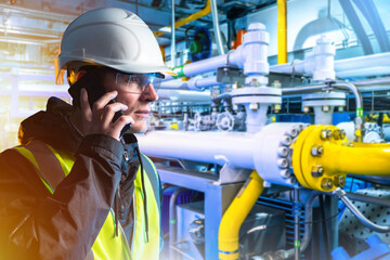 Man gas factory technologist. Industrialist guy makes phone call. Technologist near gas compressor....