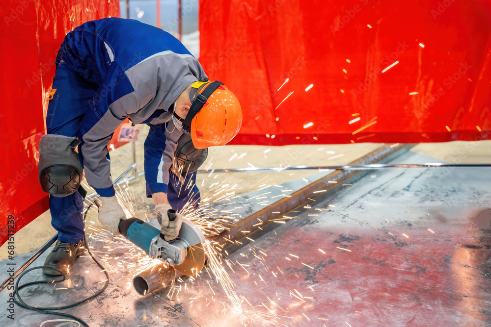 Poster man cuts pipe with circular saw. preparation for pipeline installation. worker uses hand-held circul