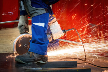 Cutting metal with circular saw. Sparks fly when processing iron sheet. Portable circular saw in...