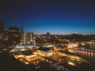 the san skyline and harbor at night, taken from a rooftop