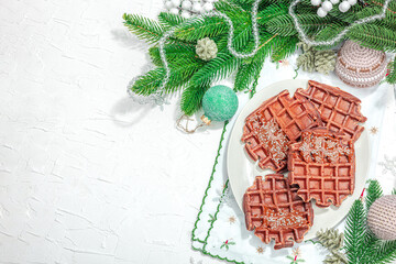 Christmas Belgian waffles with chocolate. Festive New Year dessert, traditional arrangement
