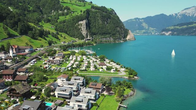 Swiss town on the shore of a mountain lake, view from a drone.