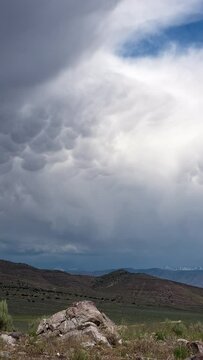 Vertical Timelapse of the clouds flowing the end of a rainstorm over Utah viewing mammatus clouds tailing the storm.