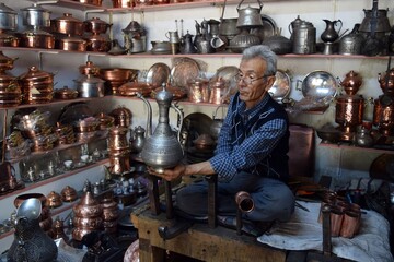 A tinsmith, in his, tinsmith's shop,The master, of working, with copper, in his shop