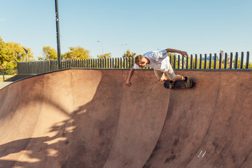 Skateboarder performing trick on ramp in skate park