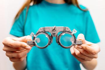 Eye test equipment, test glasses close-up in the hands of an ophthalmologist. The concept of...