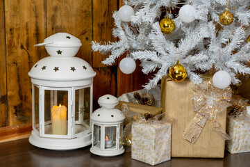 Details of the Christmas interior. Festive lamps under a white Christmas tree.