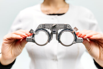 Eye test equipment, test glasses close-up in the hands of an ophthalmologist. The concept of...