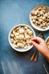 Set of various tasty breakfast cereals on light grey table, flat lay top view