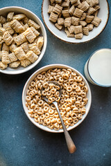 Set of various tasty breakfast cereals on light grey table, flat lay top view