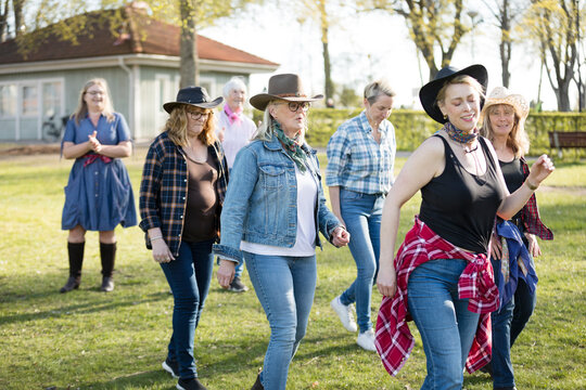 View of women dancing in autumn park