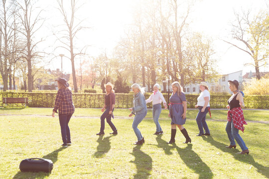 View of women dancing in autumn park