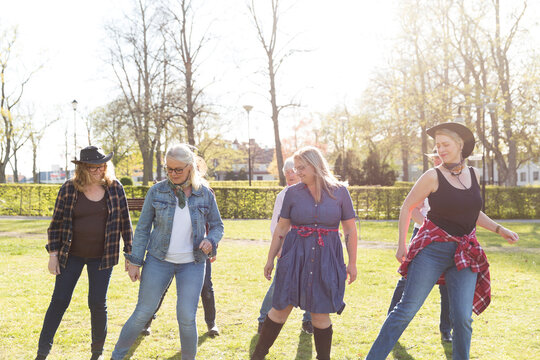 View of women dancing in autumn park