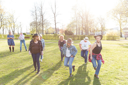View of women dancing in autumn park