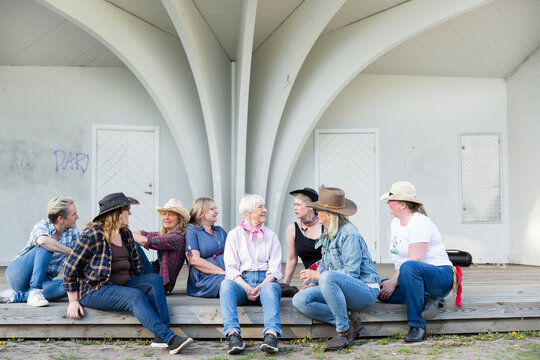 Smiling women sitting together and talking