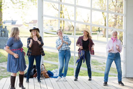 View of happy women dancing together