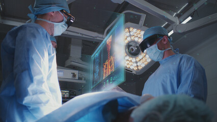 Surgeons in AR headsets operate patient in modern hospital. Doctors perform surgery using 3D...